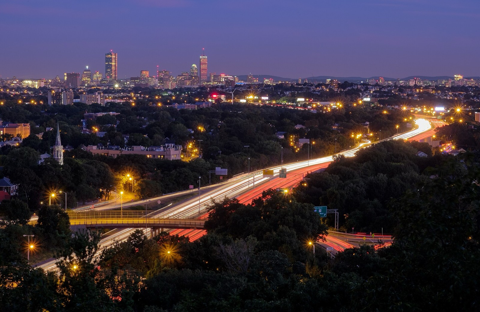 Evening traffic on Interstate 93, with the Boston skyline beyond