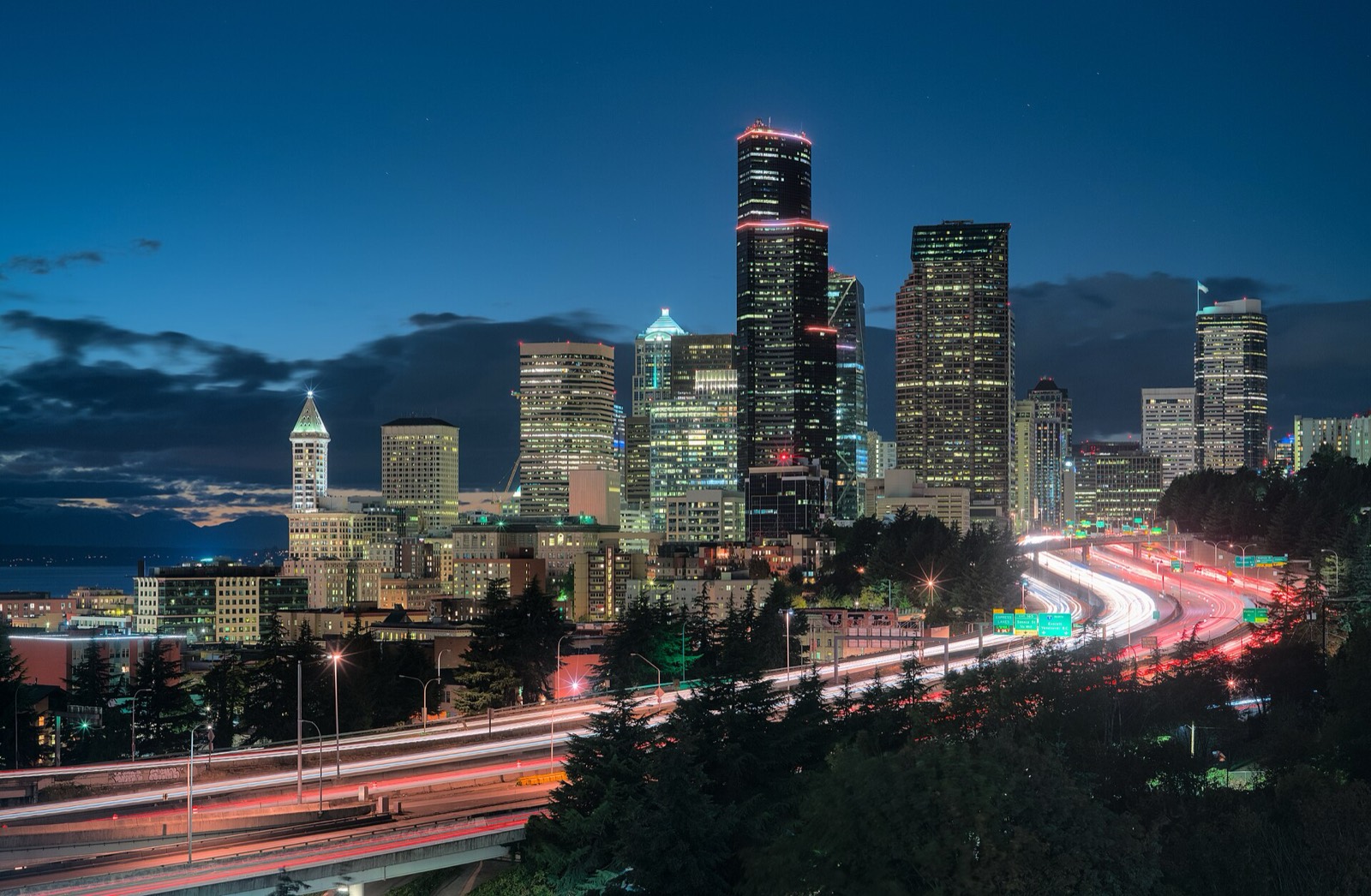 Interstate 5 traffic passing the Seattle skyline at night